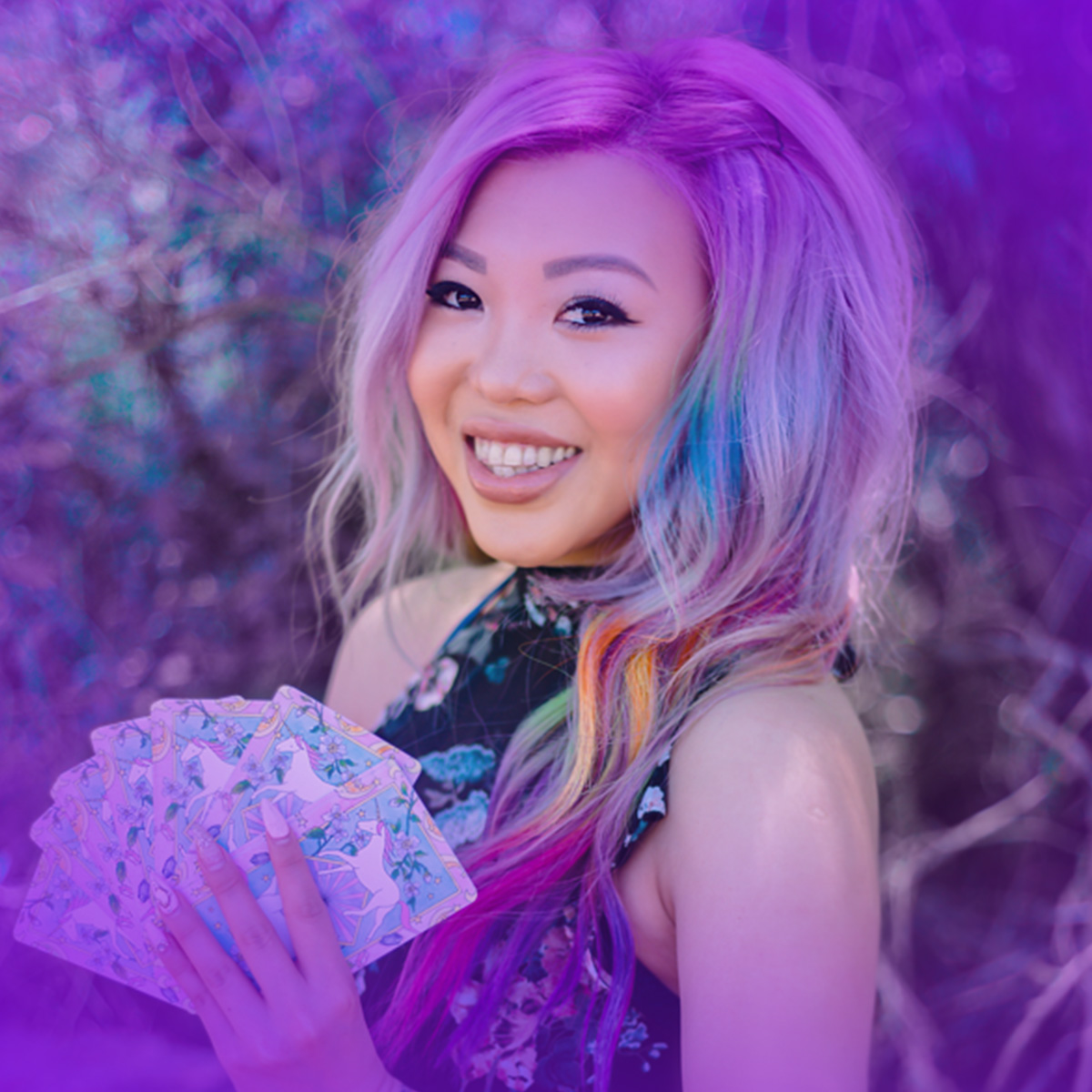 Pamela Chen smiling brightly while holding her deck of cards.